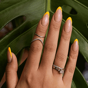 hand showing yellow french tip press on nails