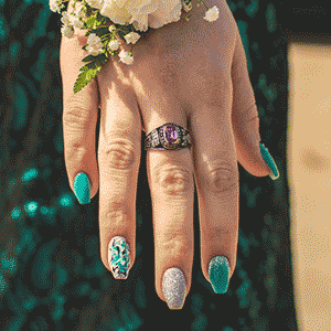 hand showing green, silver and glittery fake press on nails